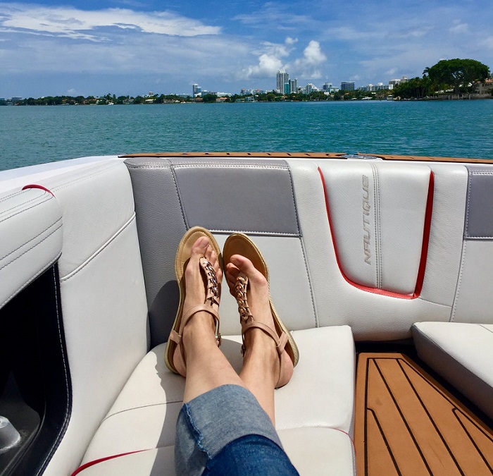 picture of a woman legs on a boat wearing jeans and walking sandals