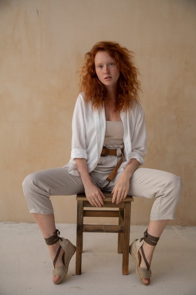 picture of woman sitting on a wooden chair 