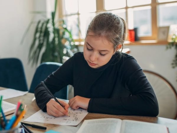 a girl studying year 8 maths textbook